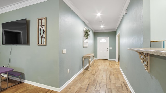 entryway with crown molding and light hardwood / wood-style flooring