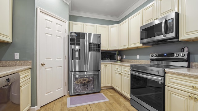 kitchen featuring stainless steel appliances, ornamental molding, cream cabinets, and light hardwood / wood-style flooring