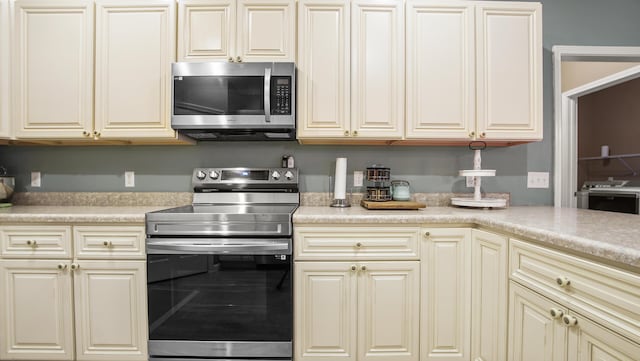 kitchen with stainless steel appliances and cream cabinets