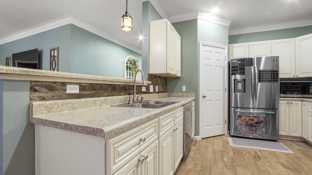 kitchen with pendant lighting, sink, light hardwood / wood-style flooring, stainless steel appliances, and ornamental molding