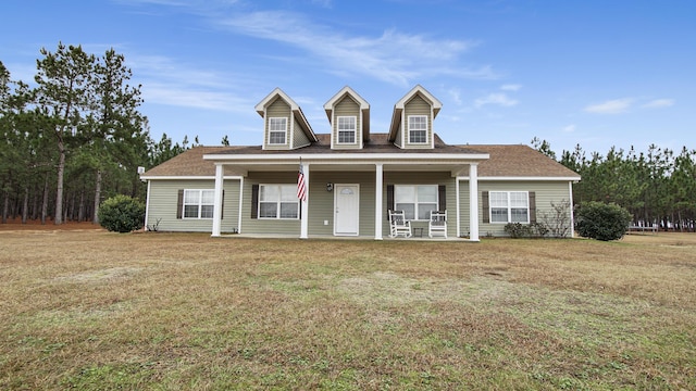 cape cod house with a porch and a front yard