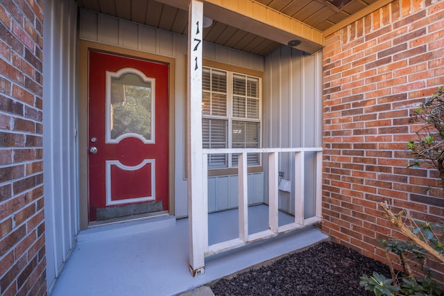 doorway to property with brick siding