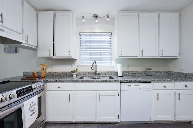 kitchen with dark stone counters, a sink, white cabinetry, dishwasher, and stainless steel range with electric stovetop