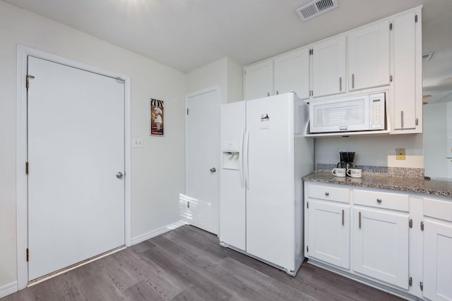 kitchen featuring white appliances, white cabinetry, dark wood-style floors, and visible vents