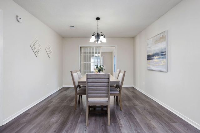 dining area featuring baseboards, visible vents, a chandelier, and dark wood-type flooring