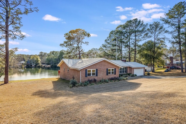 view of front facade featuring a water view and a garage