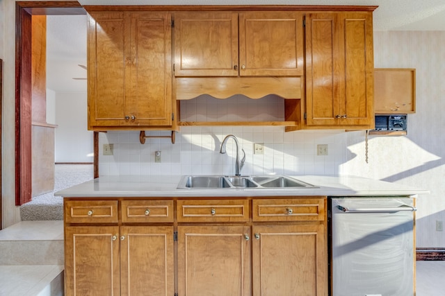 kitchen with dishwasher, tasteful backsplash, and sink