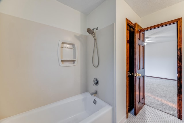 bathroom with a textured ceiling, tile patterned flooring, and tub / shower combination