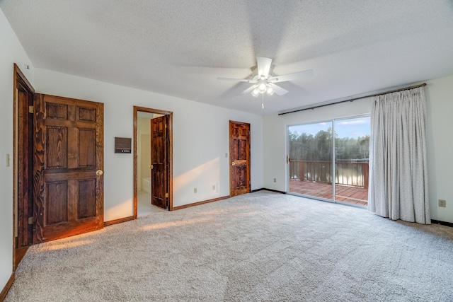 unfurnished bedroom featuring ceiling fan, light colored carpet, connected bathroom, and access to exterior