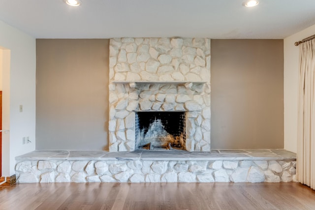 room details featuring a fireplace and hardwood / wood-style floors