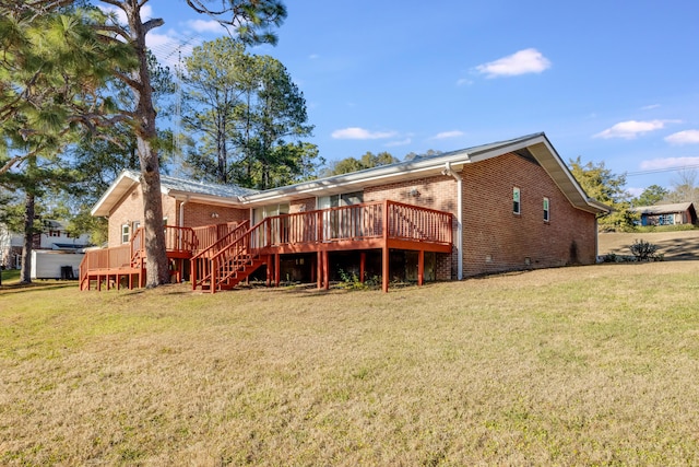 rear view of property featuring a deck and a lawn