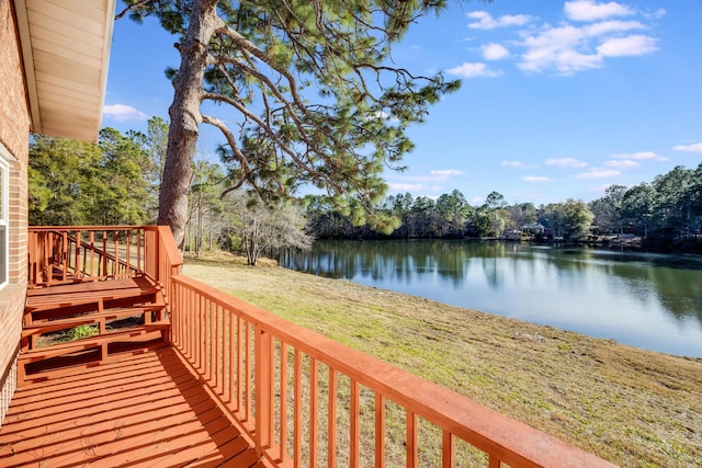 wooden terrace featuring a yard and a water view