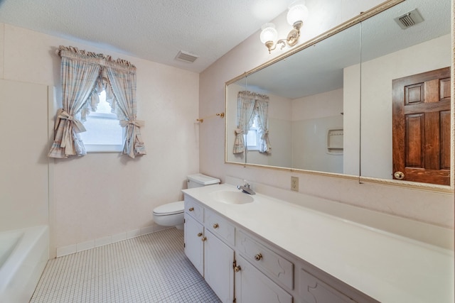 bathroom featuring a textured ceiling, tile patterned floors, vanity, and toilet