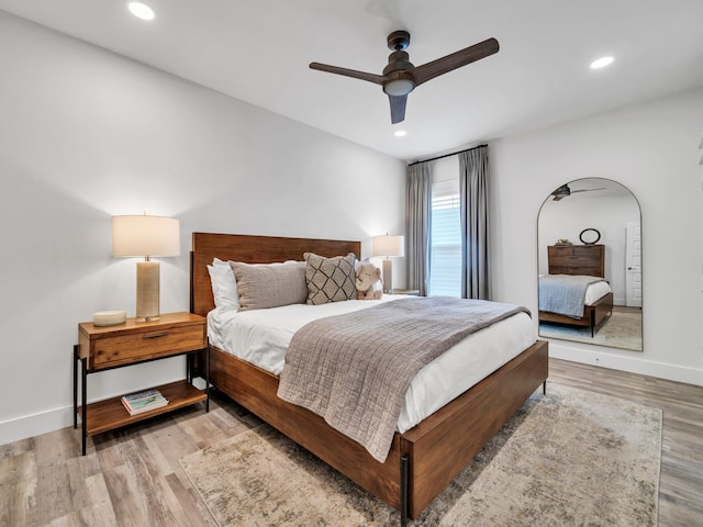 bedroom with ceiling fan and light wood-type flooring