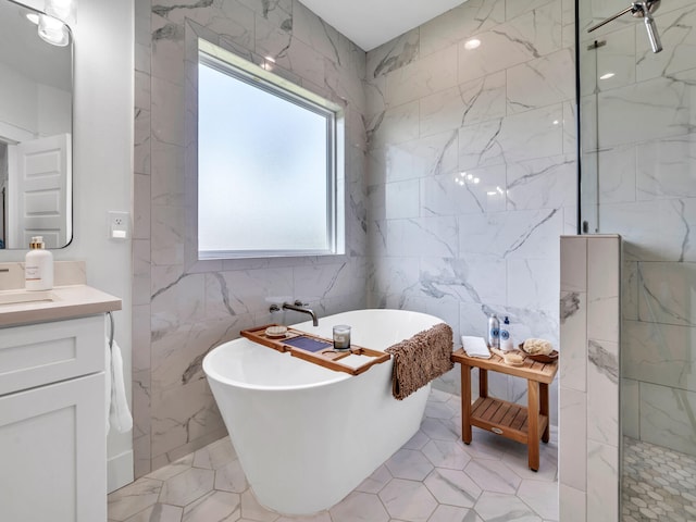 bathroom featuring plus walk in shower, tile walls, and vanity