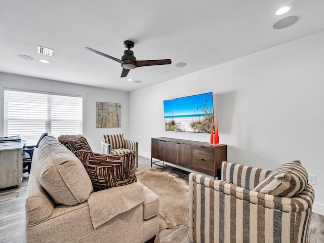 living room featuring ceiling fan and light wood-type flooring