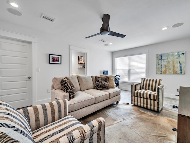 living room with wood-type flooring and ceiling fan