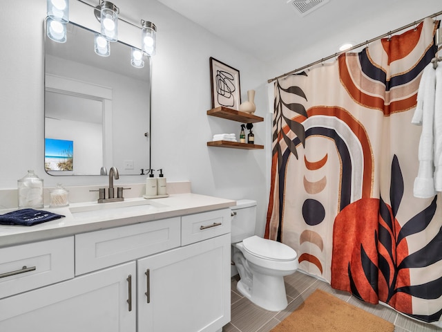 bathroom with vanity, tile patterned floors, and toilet