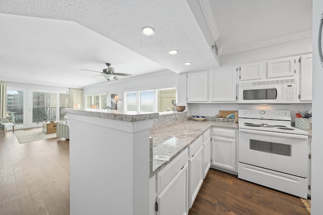 kitchen with white cabinetry, kitchen peninsula, white appliances, and dark hardwood / wood-style flooring