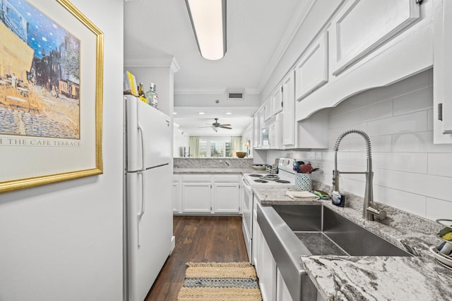 kitchen featuring white appliances, crown molding, white cabinets, and sink