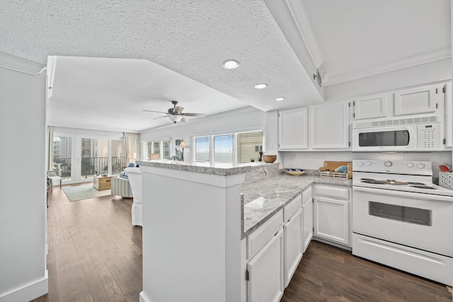 kitchen with white appliances, dark hardwood / wood-style flooring, ornamental molding, white cabinetry, and kitchen peninsula