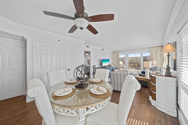 dining area with dark hardwood / wood-style flooring, ceiling fan, and crown molding