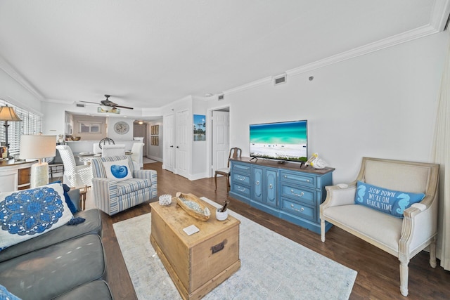 living room featuring hardwood / wood-style floors, crown molding, and ceiling fan