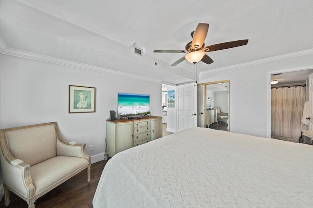 bedroom with a textured ceiling, crown molding, dark hardwood / wood-style floors, and ceiling fan