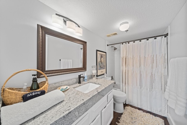 full bathroom featuring wood-type flooring, vanity, a textured ceiling, shower / bathtub combination with curtain, and toilet