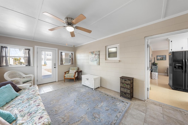 living room with ornamental molding and ceiling fan