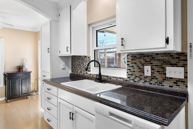 kitchen featuring sink, white cabinetry, tasteful backsplash, ornamental molding, and white dishwasher