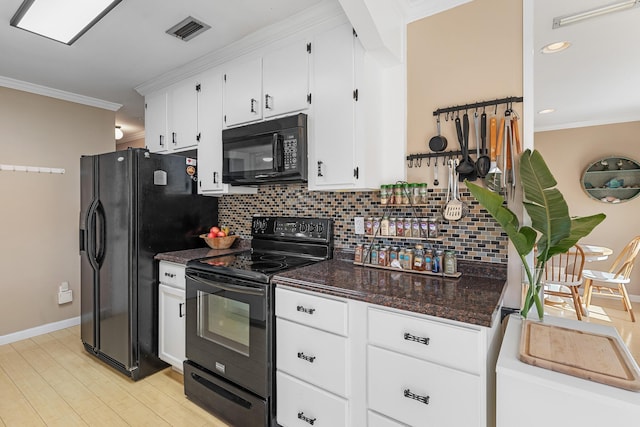 kitchen featuring crown molding, white cabinets, backsplash, and black appliances