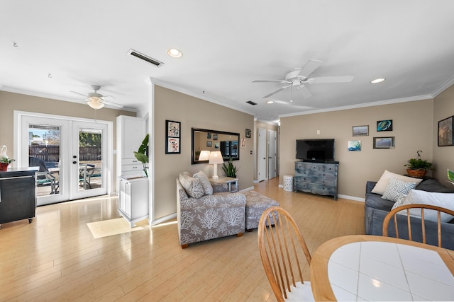 living room with french doors, ceiling fan, ornamental molding, and light wood-type flooring