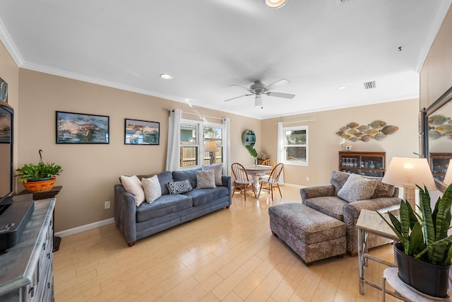 living room featuring ornamental molding, ceiling fan, and light wood-type flooring