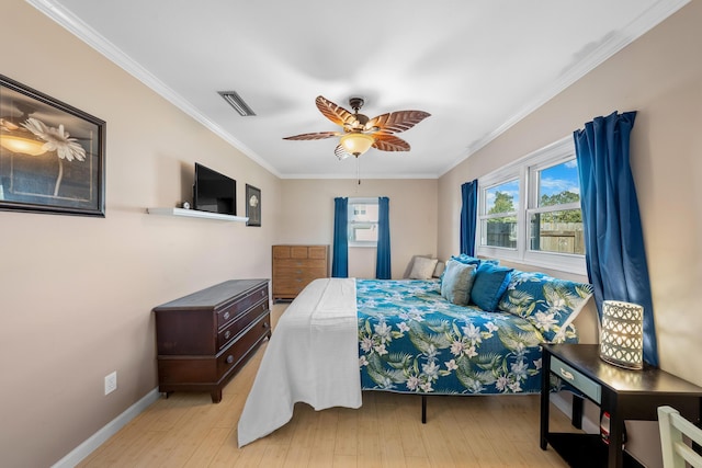 bedroom with light hardwood / wood-style flooring, ornamental molding, and ceiling fan