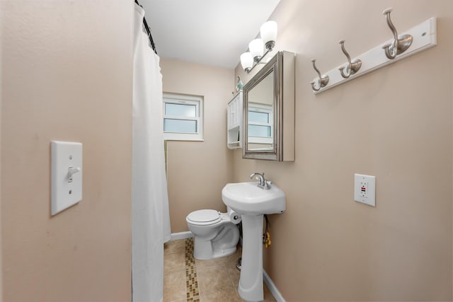 bathroom with sink, tile patterned floors, and toilet