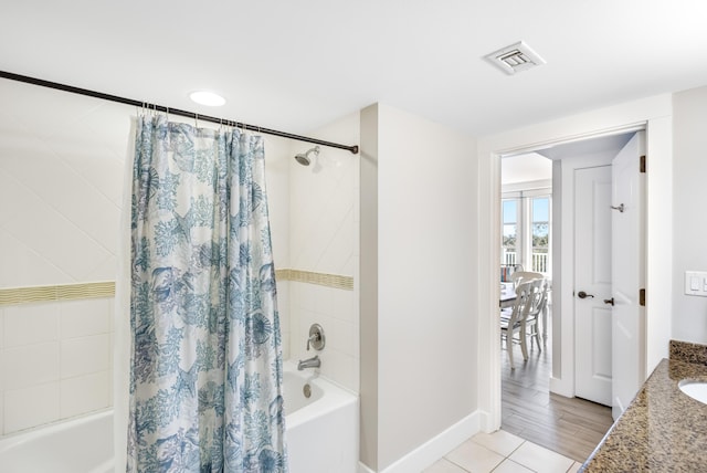 bathroom featuring tile patterned flooring, vanity, and shower / tub combo with curtain