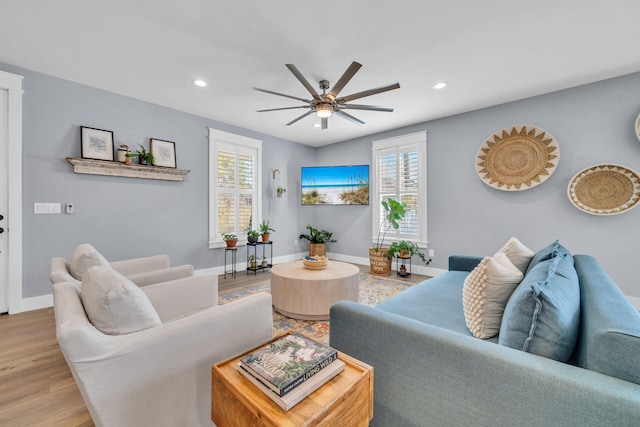 living room with light wood-type flooring and ceiling fan