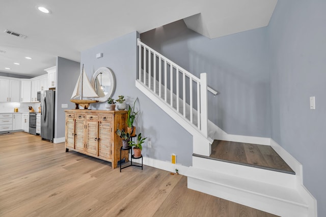 stairway with wood-type flooring