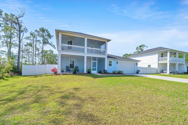 view of front of house with a balcony, a garage, and a front lawn