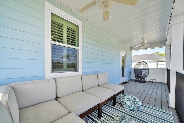 wooden deck featuring covered porch, an outdoor hangout area, and ceiling fan