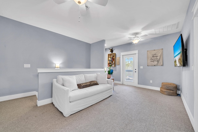 living room featuring ceiling fan and carpet