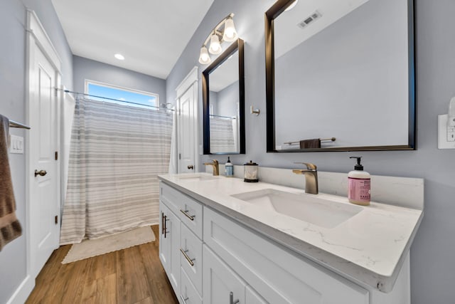 bathroom featuring hardwood / wood-style flooring and vanity