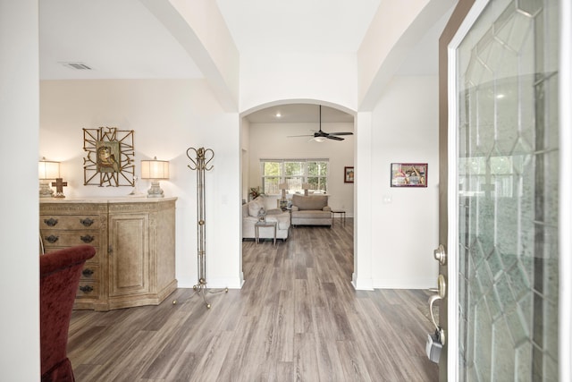 foyer entrance with ceiling fan and wood-type flooring