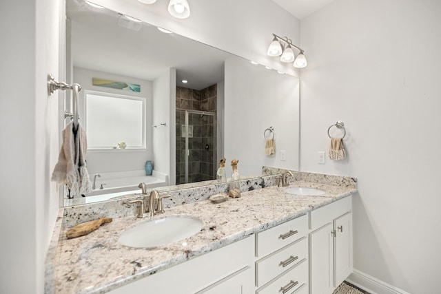 bathroom with independent shower and bath and vanity