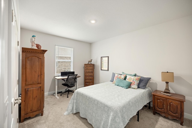 bedroom featuring light carpet