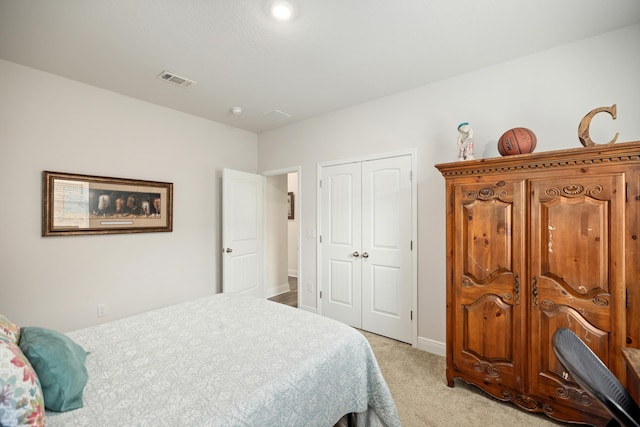 bedroom featuring a closet and light colored carpet