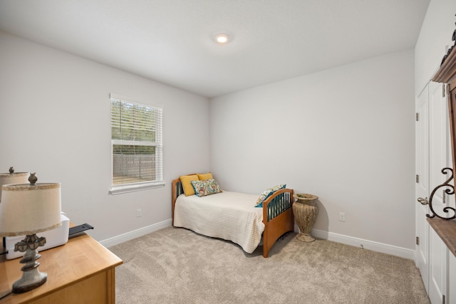 bedroom featuring light colored carpet