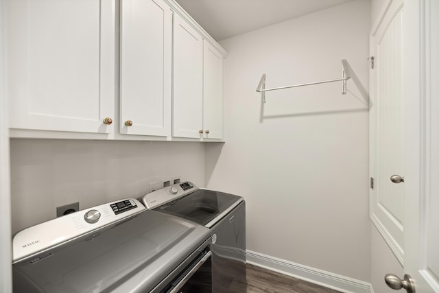 laundry area with independent washer and dryer, cabinets, and dark hardwood / wood-style floors