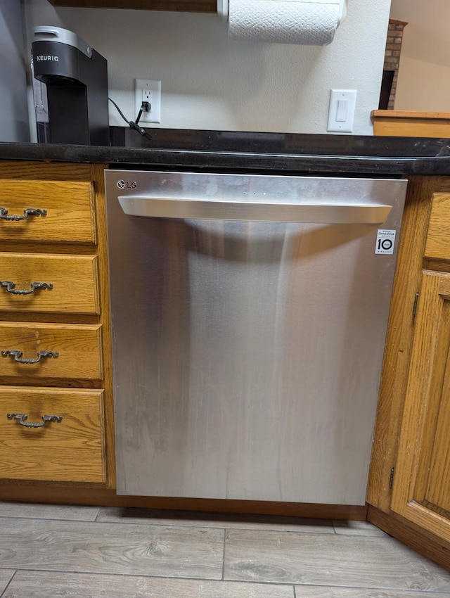 details with stainless steel dishwasher and light hardwood / wood-style floors